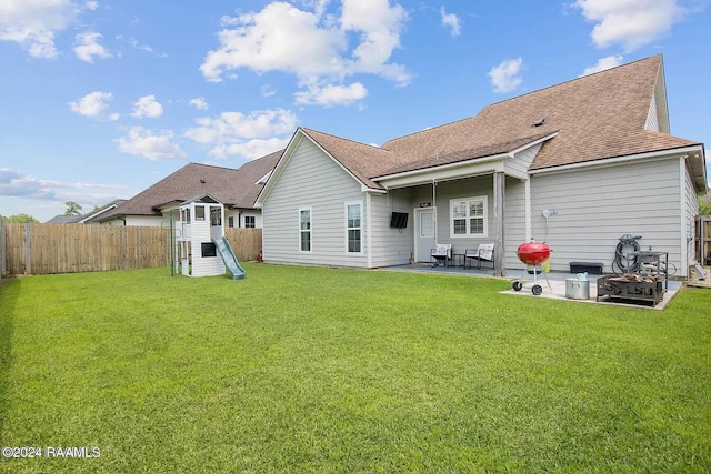 back of house featuring a lawn and a patio