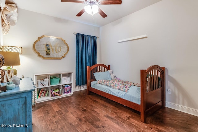 bedroom with ceiling fan and dark wood-type flooring