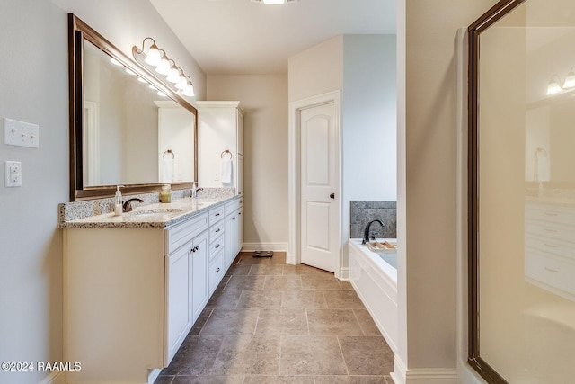 bathroom with vanity and tiled bath