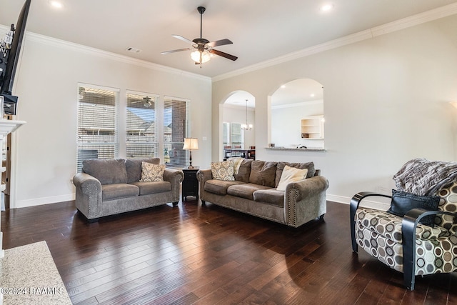 living room featuring dark hardwood / wood-style floors, ornamental molding, and ceiling fan with notable chandelier