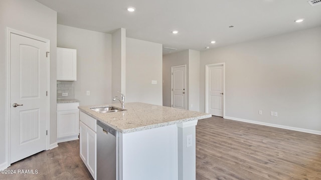 kitchen featuring sink, stainless steel dishwasher, hardwood / wood-style floors, a kitchen island with sink, and white cabinets