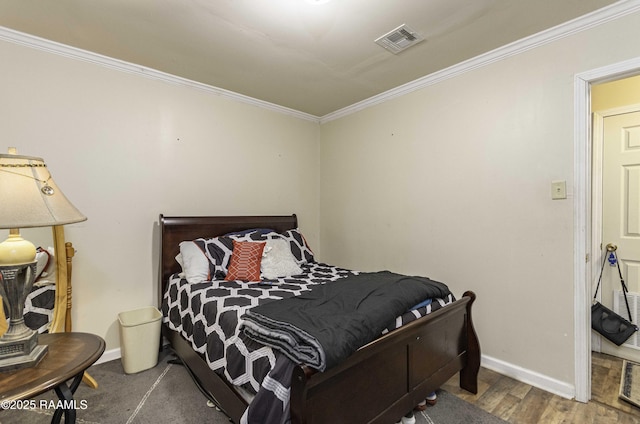 bedroom with hardwood / wood-style flooring and ornamental molding