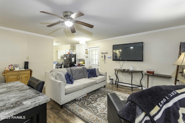 living room featuring dark hardwood / wood-style floors, ceiling fan, and crown molding