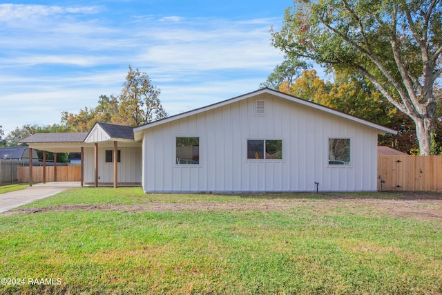 ranch-style house with a front yard and a carport