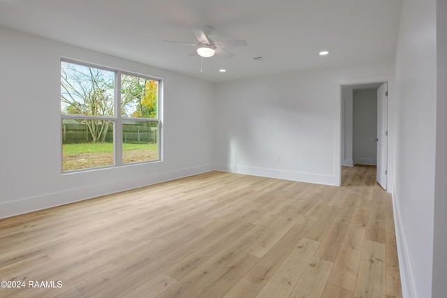 spare room featuring ceiling fan and light hardwood / wood-style flooring