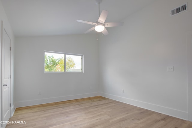 unfurnished room featuring ceiling fan, light hardwood / wood-style flooring, and lofted ceiling