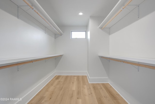 spacious closet with light hardwood / wood-style floors