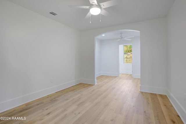 empty room with light hardwood / wood-style floors and ceiling fan