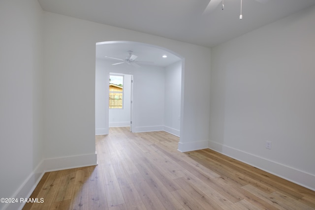 empty room featuring ceiling fan and light hardwood / wood-style floors