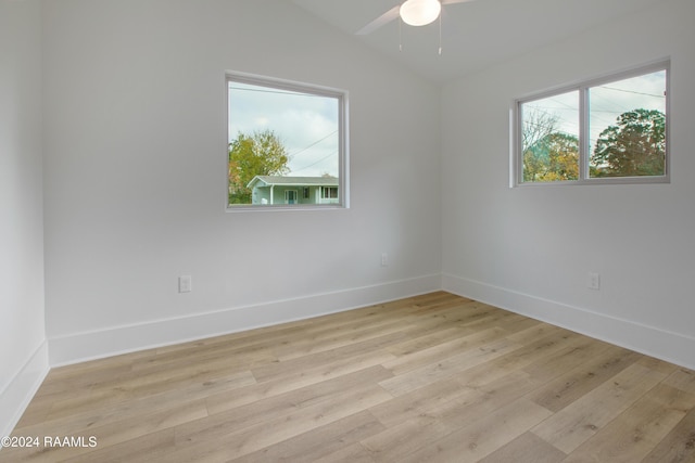 unfurnished room featuring ceiling fan, lofted ceiling, and light wood-type flooring