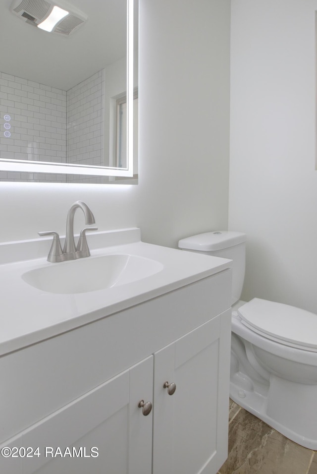 bathroom with vanity, wood-type flooring, and toilet