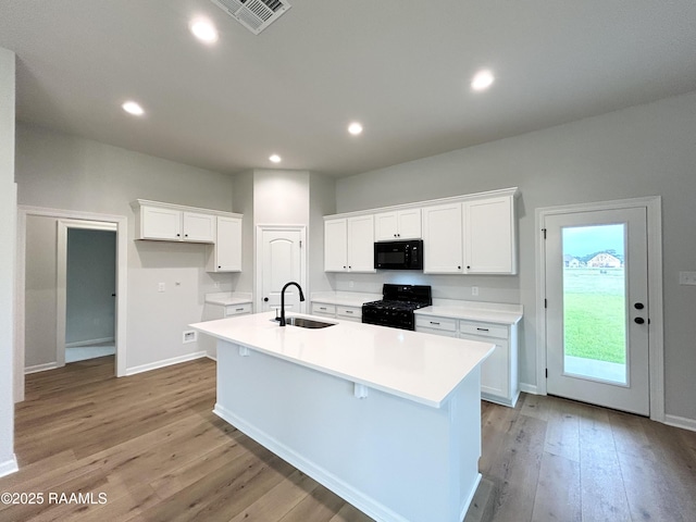 304 Weaver Way, Maurice, LA 70555 - kitchen featuring black appliances, a sink, a kitchen island with sink, white cabinets, and light wood finished floors