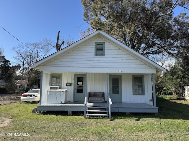 bungalow-style house with covered porch and a front yard