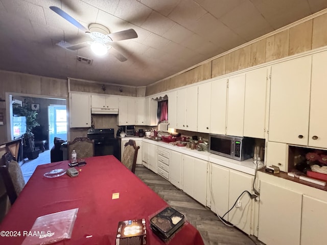 kitchen with ceiling fan, dark hardwood / wood-style flooring, white cabinetry, and black range with electric cooktop