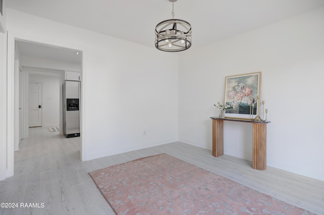 interior space featuring a chandelier and light wood-type flooring