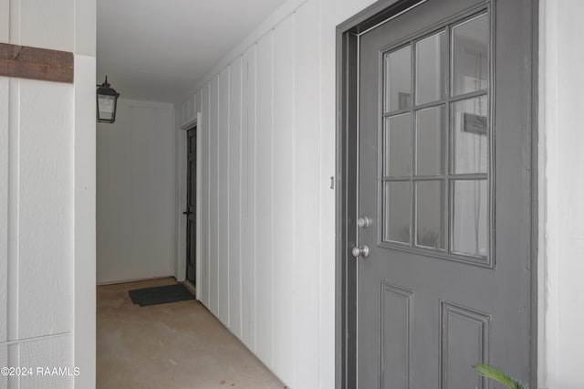 hall featuring wooden walls