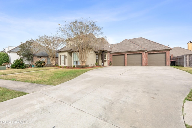 view of front of house featuring a front lawn and a garage