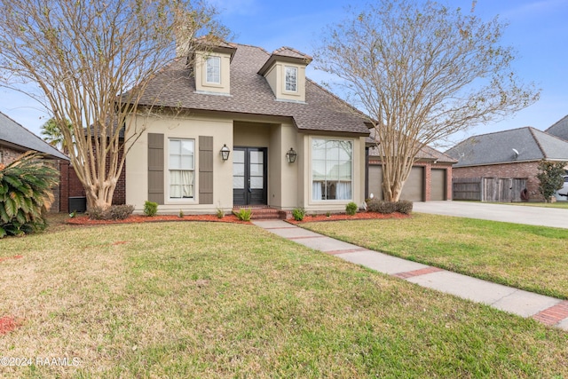 view of front facade with a garage and a front lawn