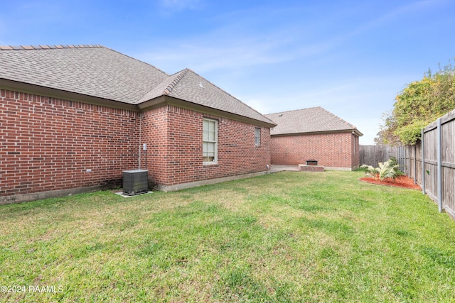 rear view of house with a patio area and a lawn