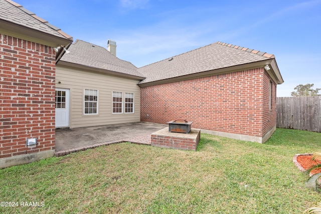 rear view of property featuring a patio area and a yard