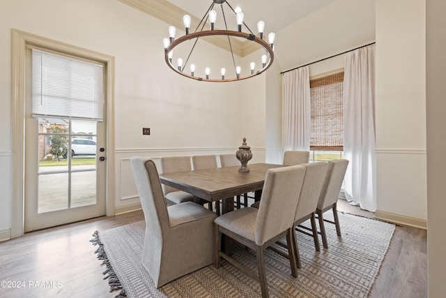 dining space featuring light hardwood / wood-style floors and an inviting chandelier