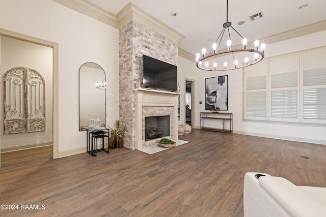 living room featuring a stone fireplace, dark hardwood / wood-style flooring, a notable chandelier, and ornamental molding