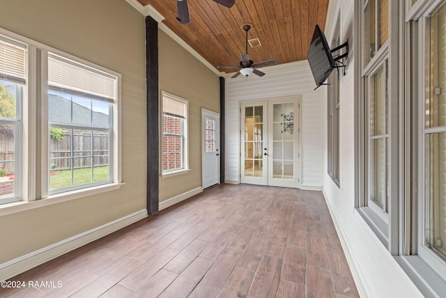 unfurnished sunroom featuring french doors, ceiling fan, and wood ceiling