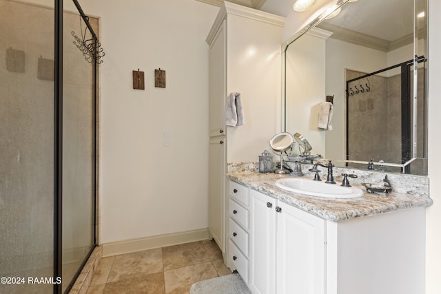 bathroom with ornamental molding, vanity, and a shower with shower door