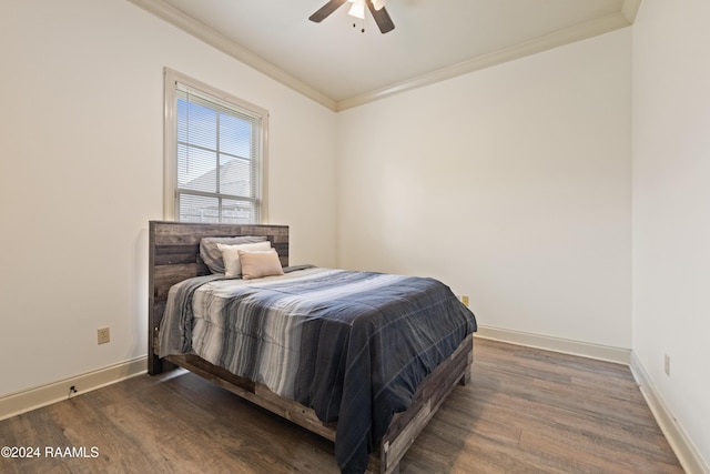 bedroom featuring ceiling fan, crown molding, and dark wood-type flooring