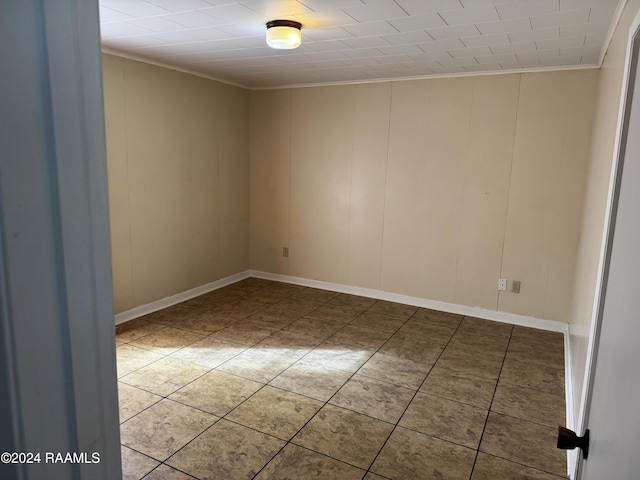 tiled empty room with crown molding