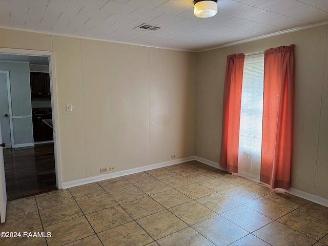 tiled empty room with crown molding