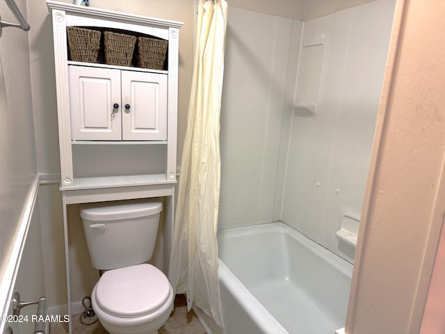 bathroom featuring shower / bath combo and toilet