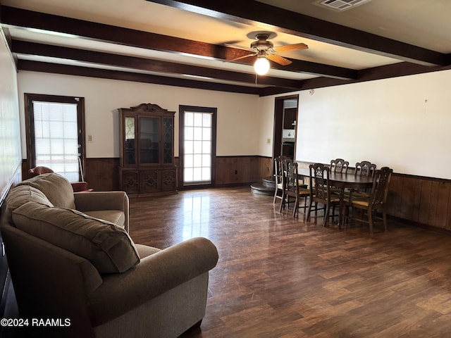 living room with beam ceiling, ceiling fan, and dark wood-type flooring