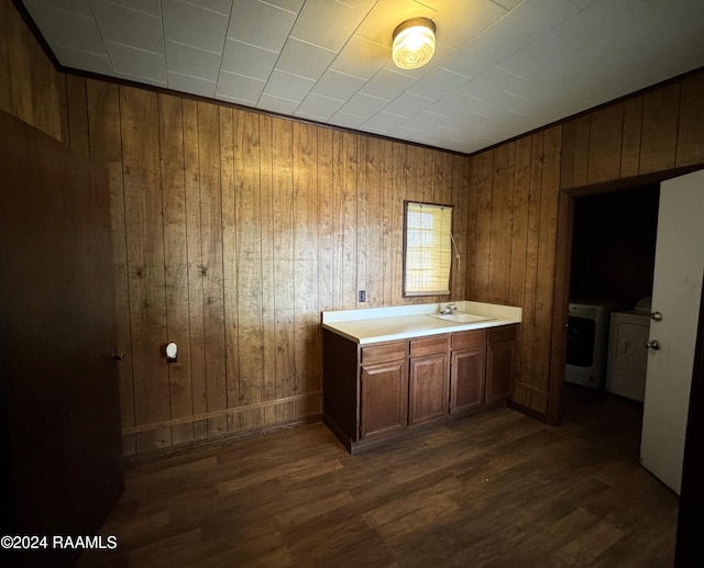 bathroom with separate washer and dryer, wood walls, vanity, and wood-type flooring