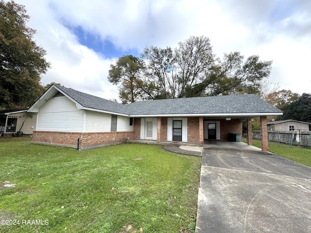 ranch-style house featuring a front yard and a carport