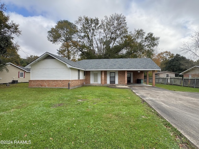 ranch-style house featuring a carport and a front lawn