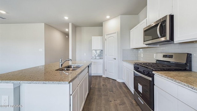 kitchen featuring a center island with sink, sink, stainless steel appliances, and dark wood-type flooring