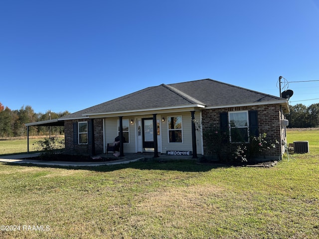 ranch-style home featuring a porch, central AC unit, and a front yard