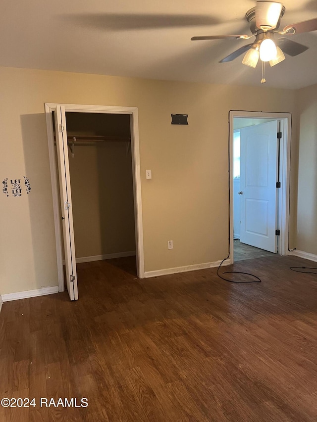 unfurnished bedroom featuring ceiling fan, dark hardwood / wood-style floors, and a closet