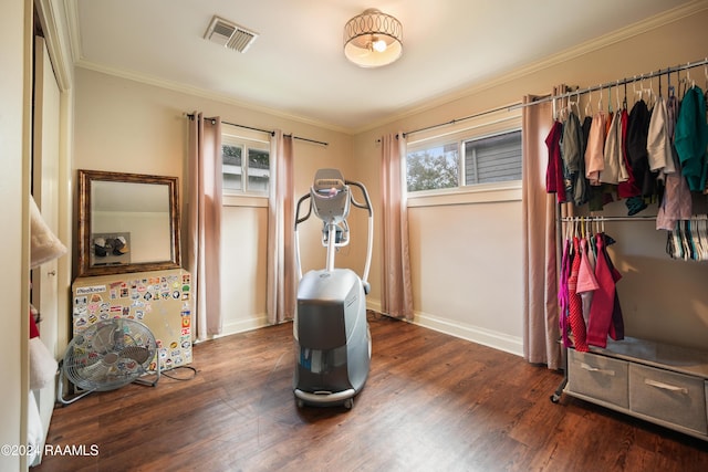 exercise area with crown molding and dark hardwood / wood-style flooring