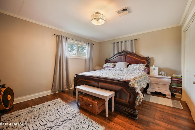 bedroom with dark hardwood / wood-style floors and crown molding