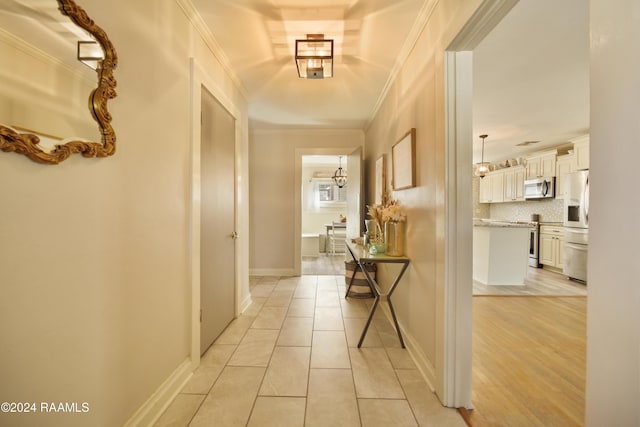 corridor featuring crown molding and light wood-type flooring