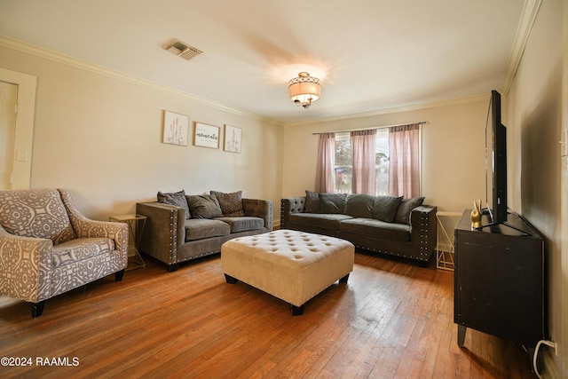 living room with crown molding and hardwood / wood-style floors