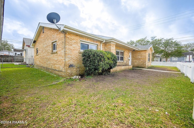 view of property exterior with a yard