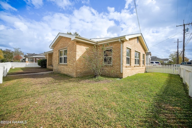 back of house with a yard