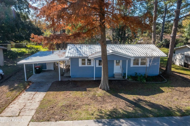 single story home with a front lawn and a carport