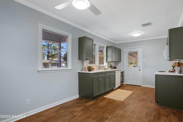 kitchen featuring crown molding, white appliances, dark wood-type flooring, and a wealth of natural light