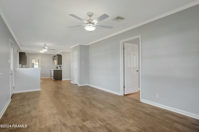 unfurnished living room featuring hardwood / wood-style flooring, ceiling fan, and ornamental molding