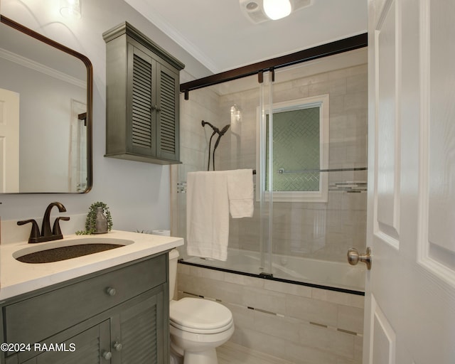 bathroom with vanity, toilet, and ornamental molding