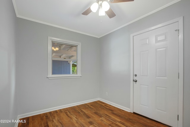 spare room with ceiling fan, crown molding, and dark wood-type flooring